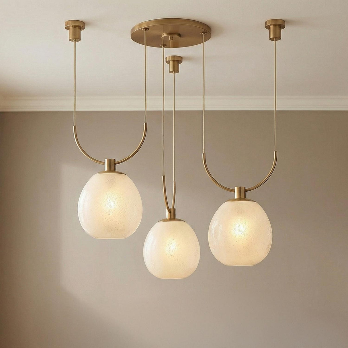Orly 3 Light Swag Chandelier 36", Patina Brass and Seeded Cloud Glass globe Chandelier in a Contemporary Dining Room with neutral walls.