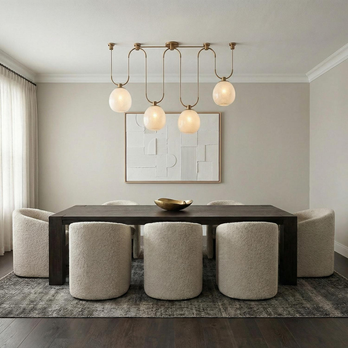 Orly 4 Light Linear Chandelier 58", Patina Brass and Seeded Cloud Glass globe Chandelier in a Contemporary Dining Room with boucle chairs.