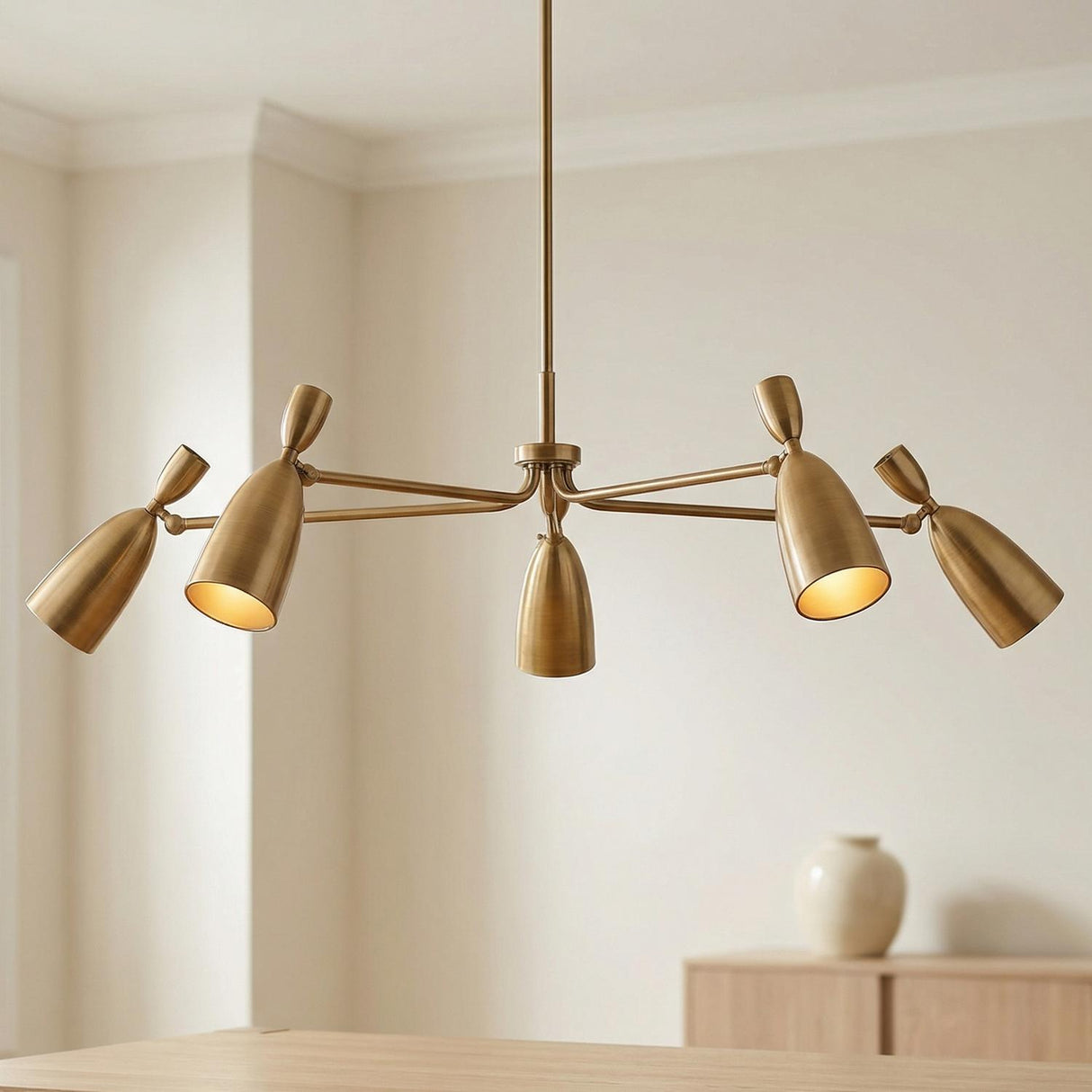 Hyla 5 Light Chandelier 50", Patina Brass geometric chandelier in a Mid-Century Dining Room with a light oak table and white vase.