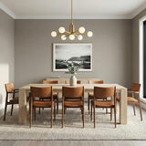 Satin Brass globe chandelier in a Mid-Century Dining Room with cognac leather chairs and a light oak table.