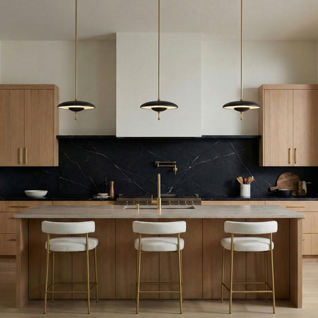 Lloyd Medium LED Pendant 14", Black and Satin Brass geometric pendant in a Modern Kitchen with a black marble backsplash.