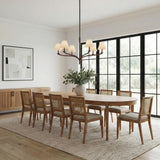 Valen 6 Light Chandelier 42", Forged Bronze leaf design Chandelier in a Transitional Dining Room with cane-back chairs and an oak table.