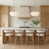 Uma Fabric Pendant 22", Brushed Brass scalloped Pendant in a Contemporary Kitchen with a white marble island and bouclé stools.