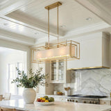 Tilda Linear Pendant 42", Brass geometric pendant in a Modern Farmhouse Kitchen with a white marble island and shiplap ceiling.