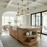 A transitional kitchen features three matte white and aged brass Drew Medium Pendants over a wood island with marble countertops beneath a white coffered ceiling.