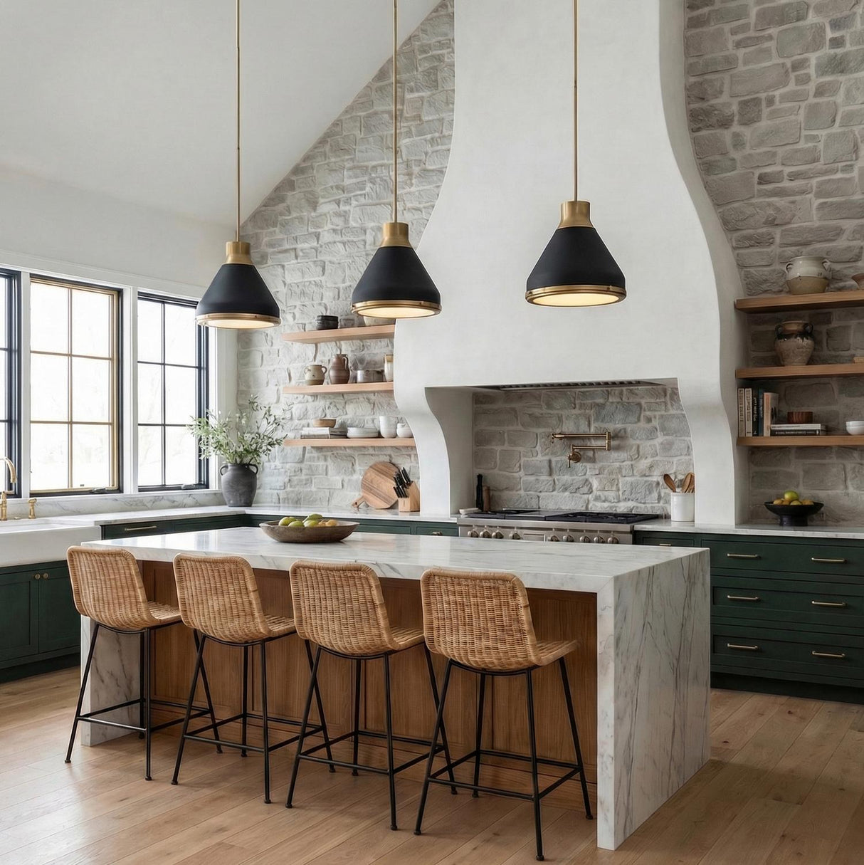 Kitchen featuring Drew Medium Pendant 19", Matte Black and Aged Brass over a marble waterfall island with woven barstools and green cabinetry under a sloped ceiling.