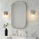 Kurt Polished Nickel scalloped glass Wall Sconce in a Transitional Bathroom with a white marble backsplash and oval mirror.