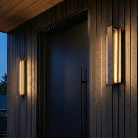 Zenith Bronze 24" linear Outdoor Wall light in a Modern Outdoor entryway with dark vertical wood siding and a black door.