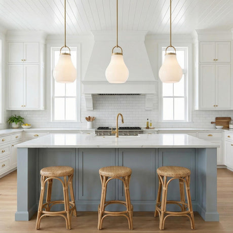 Naya Medium Pendant 12", Satin Brass and Opal Glass globe Pendant in a Modern Farmhouse Kitchen with a white marble island and stools.