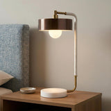 Amadeo Table Lamp 24", Brown and Heritage Brass globe Table Lamp in a Modern Bedroom with a blue textured headboard.