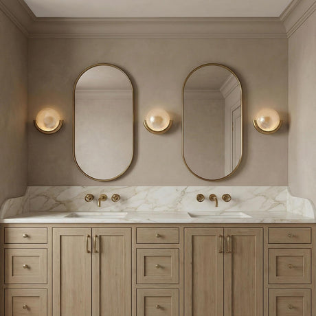 Soleil LED Wall Sconce 11", Antique Brass globe Wall Sconce in a Transitional Bathroom with a white marble double vanity.
