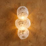 Malina Wall Sconce 30", Antique Brass and Art Glass globe Wall Sconce in a Contemporary Entryway with a textured plaster wall.