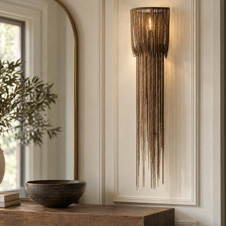 A transitional foyer features the Talon Extra Large Wall Sconce in antique burnished brass mounted on wall paneling beside an arched mirror and dark wood console table.