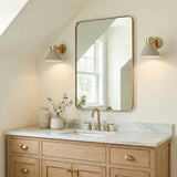 Cosette Adjustable Wall Sconce 8", Soft Taupe and Antique Brass geometric wall sconce in a Modern Farmhouse Bathroom with a marble vanity.
