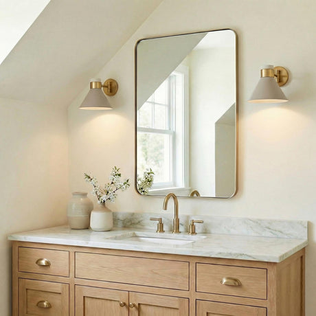 Cosette Adjustable Wall Sconce 8", Soft Taupe and Antique Brass geometric wall sconce in a Modern Farmhouse Bathroom with a marble vanity.