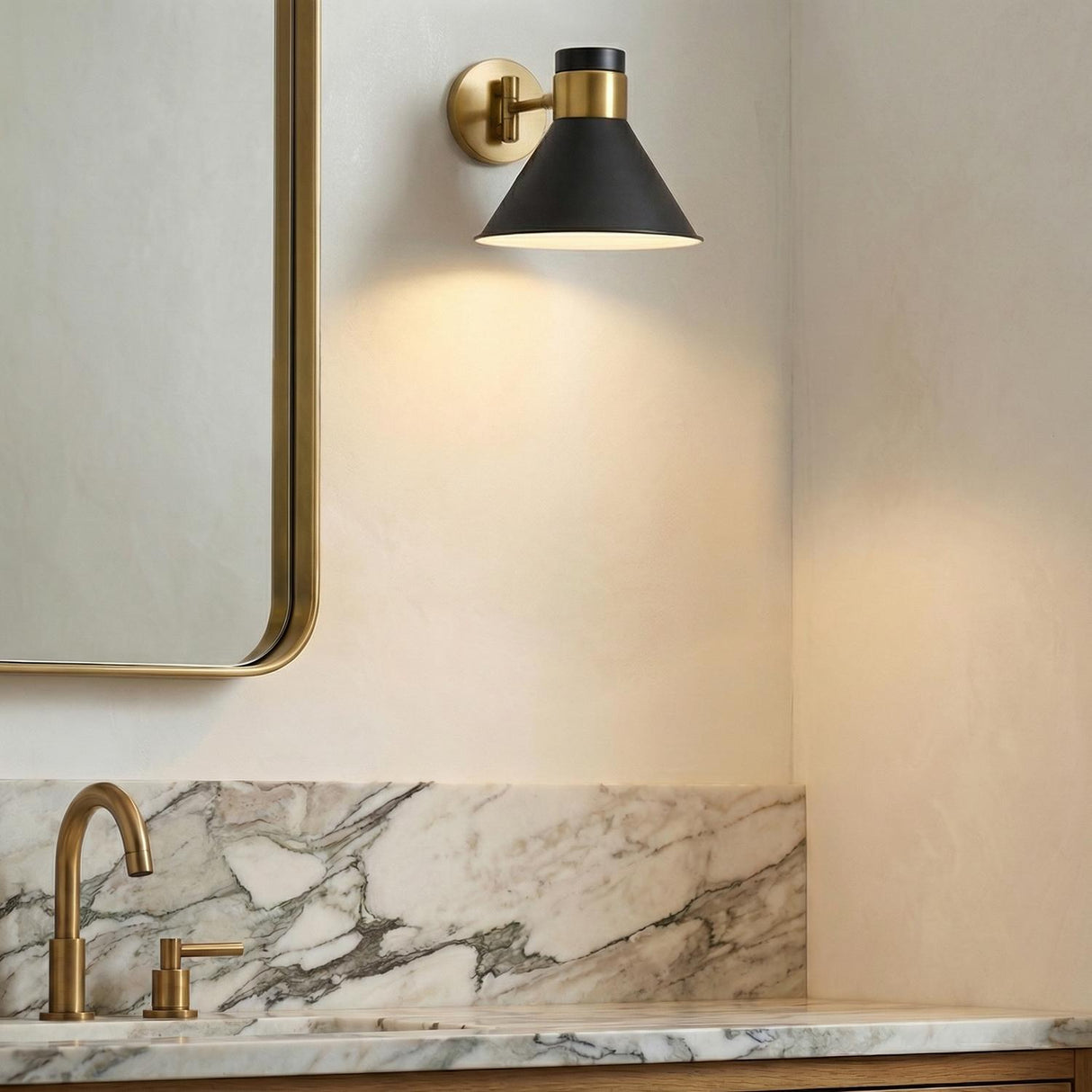 Cosette Adjustable Wall Sconce 8", Urban Bronze and Antique Brass geometric Wall Sconce in a Modern Bathroom with a white marble vanity.