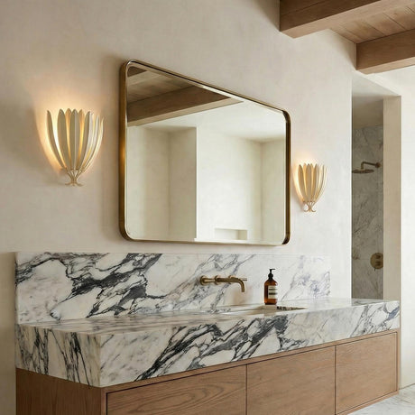 Yasmin Wall Sconce 13", Cream leaf design Wall Sconce in a Contemporary Bathroom with a marble vanity and brass mirror.