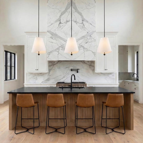 Jada White scalloped conical pendant in a Modern Farmhouse Kitchen with a white marble backsplash and leather barstools.