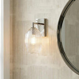 Fiora Wall Sconce, Polished Nickel ribbed glass wall sconce in a Transitional Bathroom with a round silver mirror and textured wallpaper.