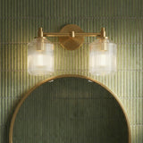 Lathan 2 Light Vanity 15", Modern Brass linear vanity in a Modern Bathroom with green vertical tile and a round gold mirror.