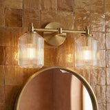 Lathan 2 Light Vanity 15", Modern Brass geometric Vanity in a Mediterranean Bathroom with zellige tile and a round gold mirror.