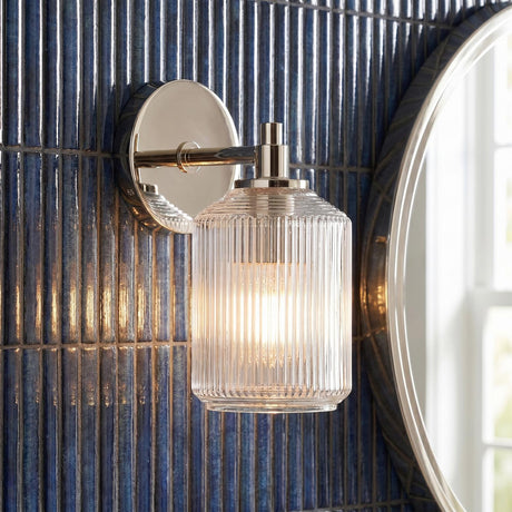 Lathan Wall Sconce 9", Polished Nickel linear Wall Sconce in a Contemporary Bathroom with blue vertical tile and a round mirror.