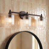 Lathan 3 Light Vanity 26", Aged Iron linear vanity in a Modern Farmhouse Bathroom with a round mirror and Zellige tile.