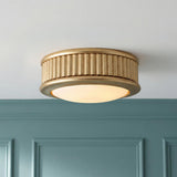Bishop Extra Small LED Flush Mount 5", Gilded Brass geometric textured Flush Mount in a Transitional Hallway with teal wall paneling.
