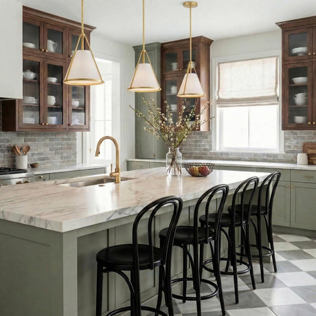 Hoyt Small Conical Pendant 9", Antique Gold geometric pendant in a Modern Farmhouse Kitchen with a white marble island and black bar stools.