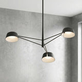 Jude LED 3 Light Chandelier 36", Black geometric Chandelier in a Modern Living Room with a textured gray concrete wall.