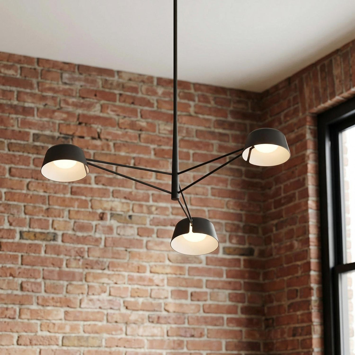 Jude LED 3 Light Chandelier 36", Black geometric Chandelier in an Industrial Living Room with an exposed brick wall.