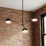 Jude LED 3 Light Chandelier 36", Black geometric Chandelier in an Industrial Living Room with an exposed brick wall.