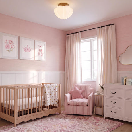 A traditional nursery with a vintage bronze and opal glass flush mount along the ceiling above a light wood crib and pink shiplap walls.