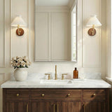 Marie Wall Sconce 10", Aged Brass and Wood scalloped Wall Sconce in a Transitional Bathroom with a marble vanity and wood cabinets.
