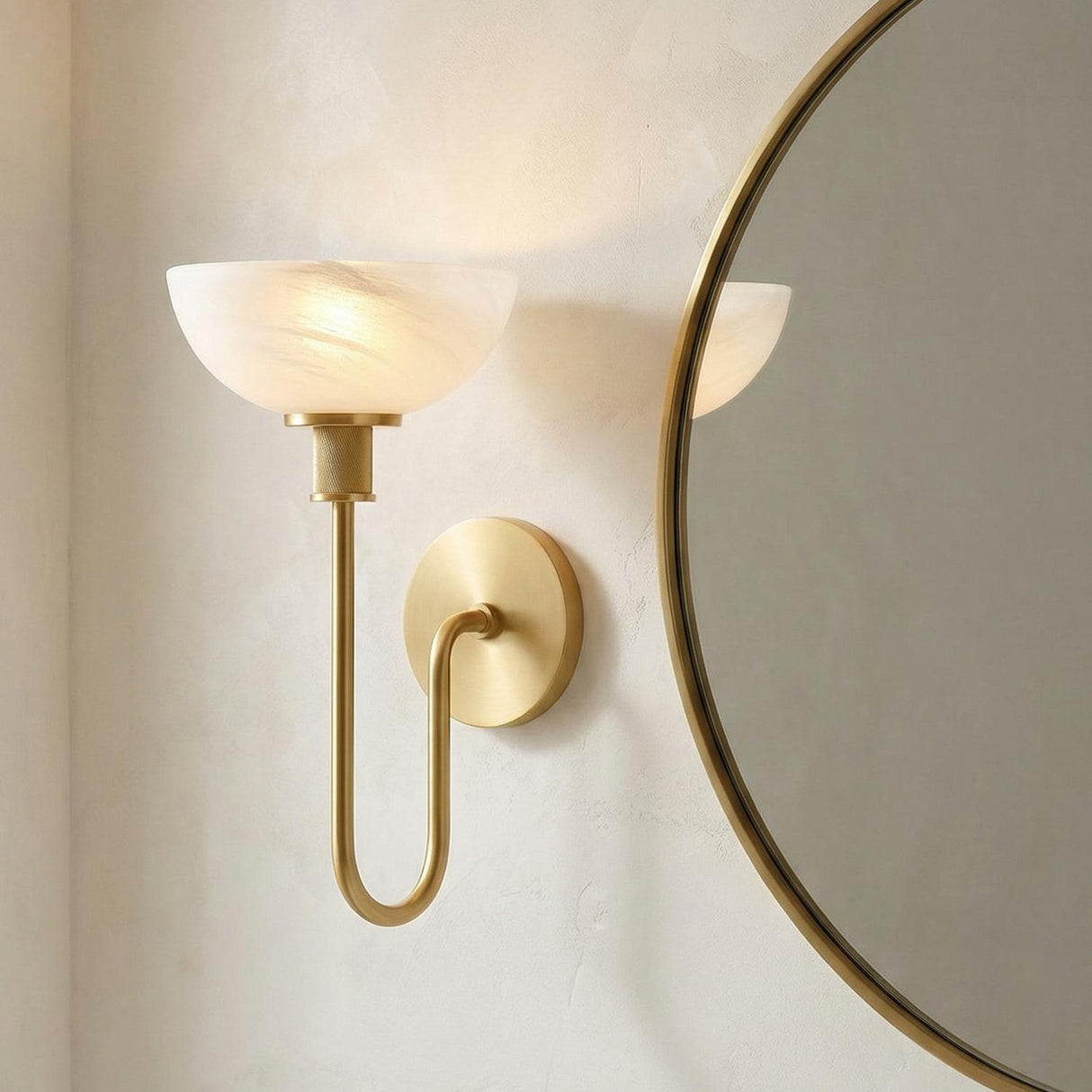 Gilda Wall Sconce 15", Aged Brass and Art Glass geometric Wall Sconce in a Contemporary Bathroom with a round brass mirror.