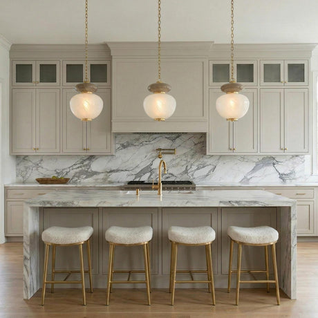 Danara Medium LED Pendant 14", Two-Tone Art Glass and Brass globe Pendant in a Transitional Kitchen with a white marble island.