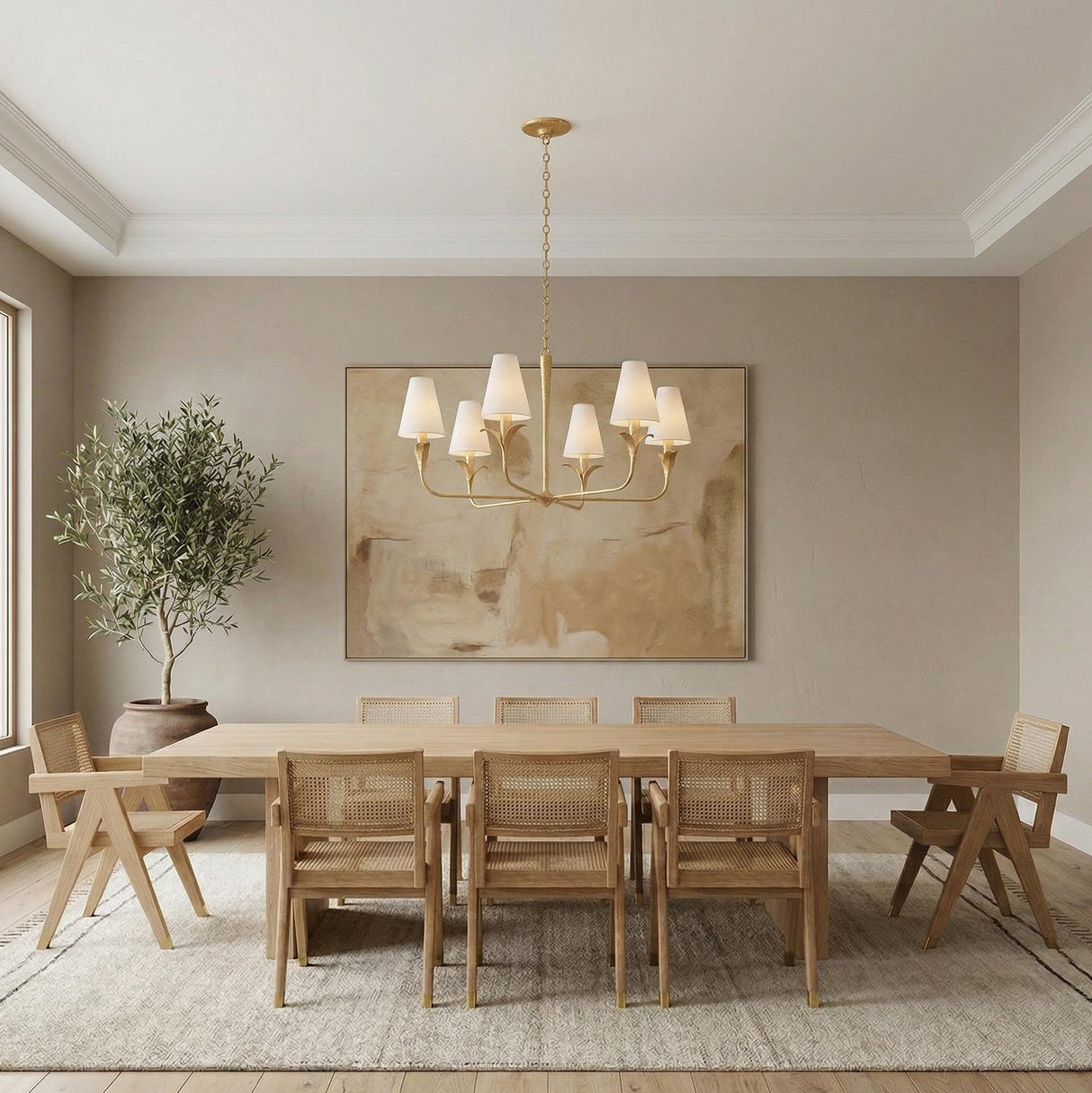 Junia 6 Light Chandelier Textured Gold leaf design Chandelier in a Transitional Dining Room with a light oak table and cane chairs.