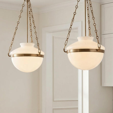 Capella Medium Pendant 16", Patina Brass and Milk Glass globe pendant in a Transitional Kitchen with white shaker cabinets.