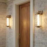 Catalina LED Outdoor Wall Light, Large 23", Patina Brass linear Outdoor Wall in a Modern Farmhouse Outdoor with a white brick wall.