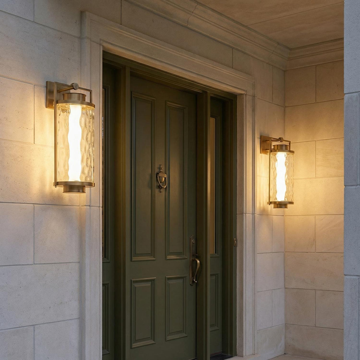 Catalina LED Outdoor Wall Light, Large 23", Patina Brass geometric wall sconce in a Transitional Outdoor entryway with a green door.
