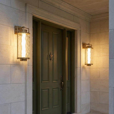 Catalina LED Outdoor Wall Light, Large 23", Patina Brass geometric wall sconce in a Transitional Outdoor entryway with a green door.