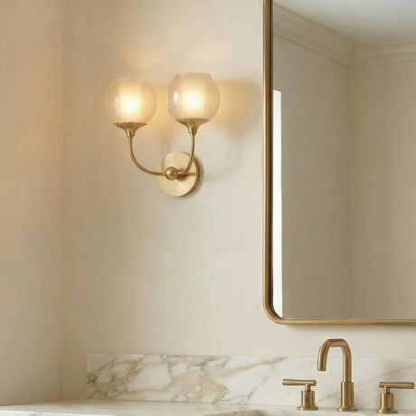 Danica Double Wall Sconce 12", Aged Brass and Champagne Glass scalloped Wall Sconce in a Transitional Bathroom with a marble vanity.