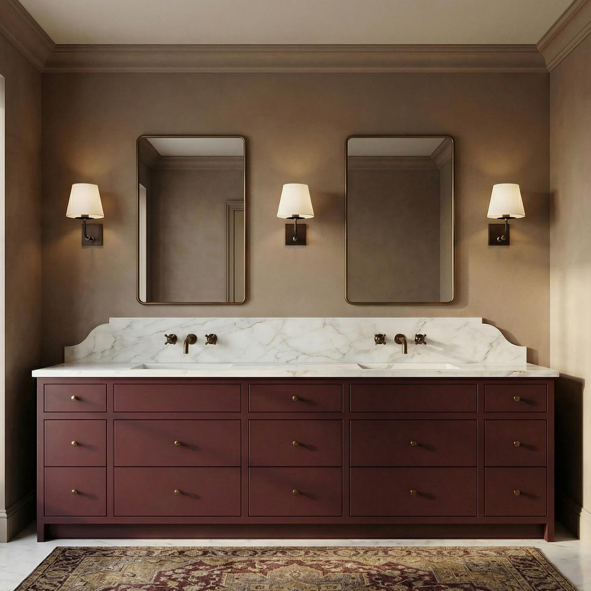 A traditional bathroom with three Eamon Wall Sconces in distressed bronze and aged brass flanking two mirrors above a burgundy vanity with a marble countertop and backsplash.