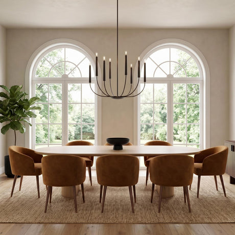 A contemporary dining room featuring an aged iron Solana 8 light chandelier over a light wood table surrounded by tan velvet chairs and arched windows.