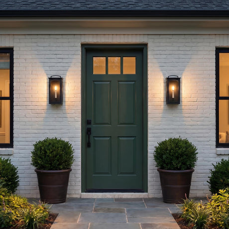 An outdoor entryway with two Barlow Outdoor Wall Lights in textured black flanking a dark green front door on a white brick house with slate tiling.