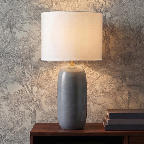 Nolette Large Table Lamp 29", Satin Storm Gray linear Table Lamp in a Transitional Office with botanical wallpaper and stacked books.