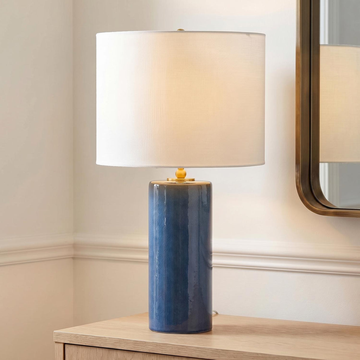 Joleigh Table Lamp 26", Cerulean Crackle geometric Table Lamp in a Transitional Entryway with a light wood console and brass mirror.