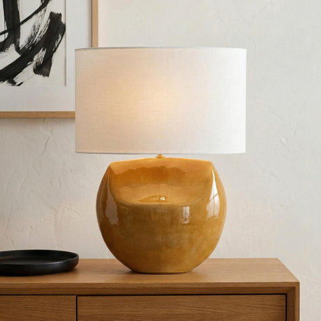Tivola Table Lamp 27", Glossy Honey geometric Table Lamp in a Modern Living Room with a wooden console and abstract art.