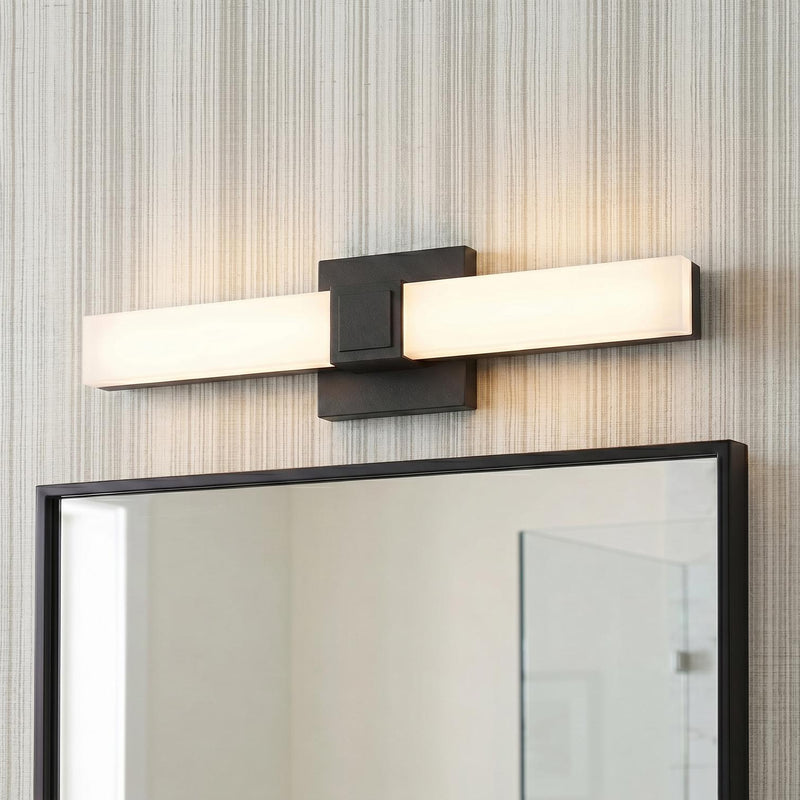 A contemporary bathroom featuring a matte black and frosted acrylic vanity bar installed above a matching black-framed mirror against gray textured wallpaper.