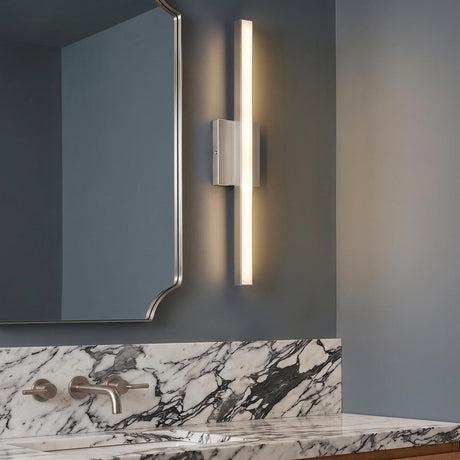 A modern bathroom featuring a Garrison LED Vanity Light 24" in brushed nickel mounted beside a silver scalloped mirror above a bold black and white marble backsplash.